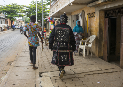 Benin, West Africa, Porto-Novo, egoun egoun spirit of the deads walking in the street with his guide to ask money to people