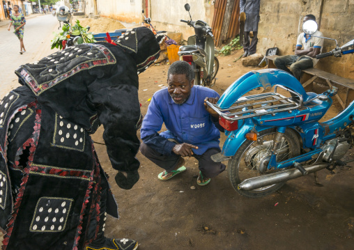 Benin, West Africa, Porto-Novo, egoun egoun spirit of the deads asks money to a garagist in exchange of blessings