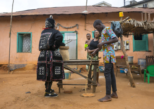 Benin, West Africa, Porto-Novo, egoun egoun spirit of the deads asks money to a family in exchange of blessings
