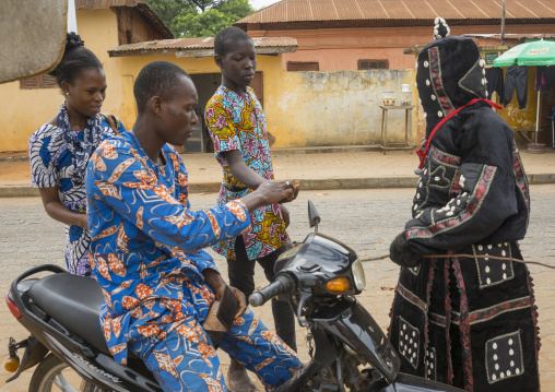 Benin, West Africa, Porto-Novo, egoun egoun spirit of the deads asks money to a driver in exchange of blessings