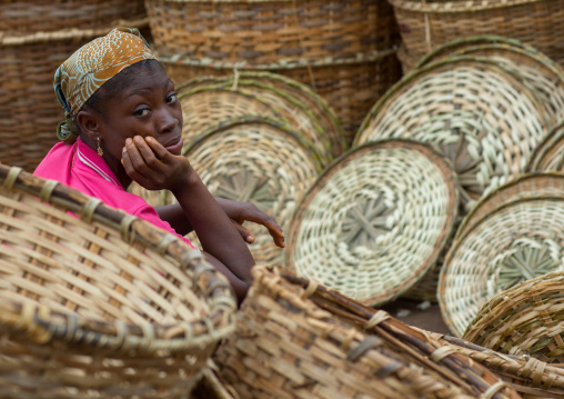 Benin, West Africa, Adjara, woman selling baskets on a market