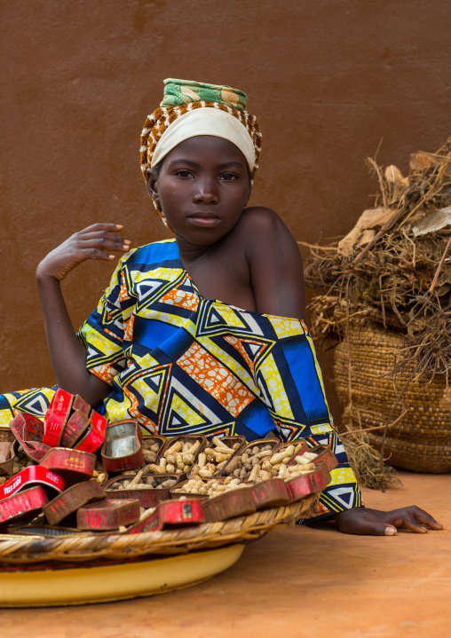 Benin, West Africa, Adjara, girl selling peanuts on a market