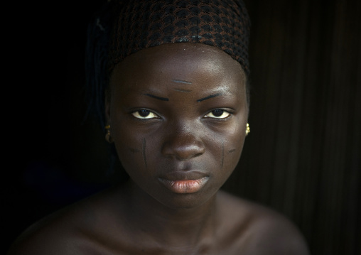 Benin, West Africa, Onigbolo Isaba, holi tribe woman covered with traditional facial tattoos and scars portrait