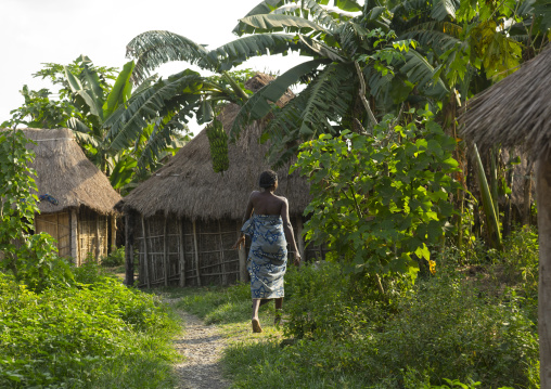 Benin, West Africa, Onigbolo Isaba, holi tribe woman passing in front of traditional houses