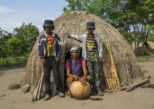 Benin, West Africa, Gossoue, a fulani peul mother with her two sons in front of their hut