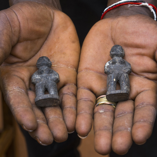 Benin, West Africa, Bonhicon, kagbanon bebe voodoo priest showing little statues that he uses to be protected when he drives his car