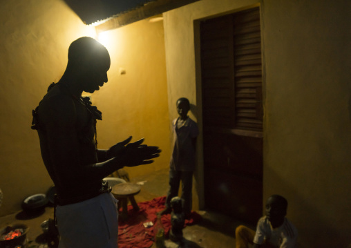 Benin, West Africa, Bonhicon, kagbanon bebe voodoo priest praying in the night during a ceremony