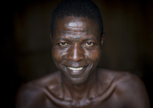 Benin, West Africa, Onigbolo Isaba, holi tribe man covered with traditional facial tattoos and scars portrait