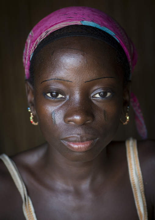 Benin, West Africa, Onigbolo Isaba, holi tribe girl covered with traditional facial tattoos and scars