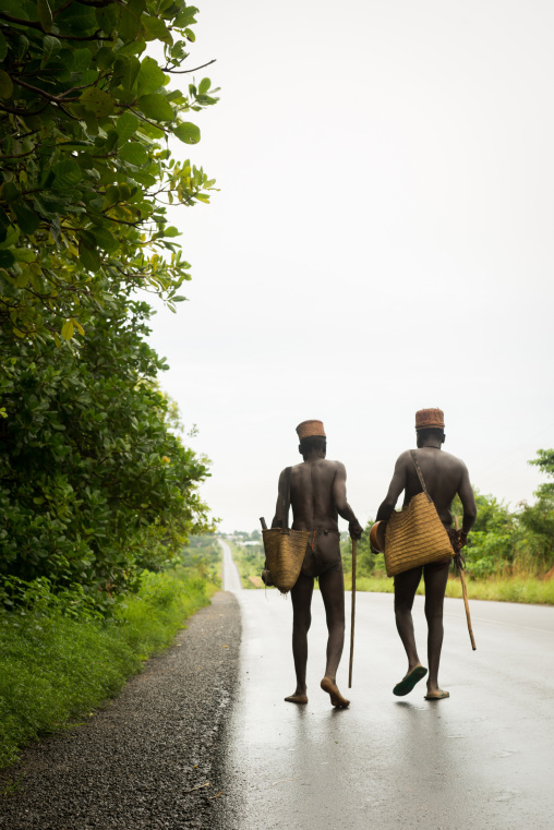 Benin, West Africa, Taneka-Koko, traditional healers walking on a concrete road