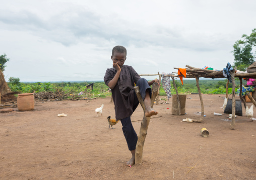 Benin, West Africa, Taneka-Koko, a fulani peul tribe boy resting on a piece of wood