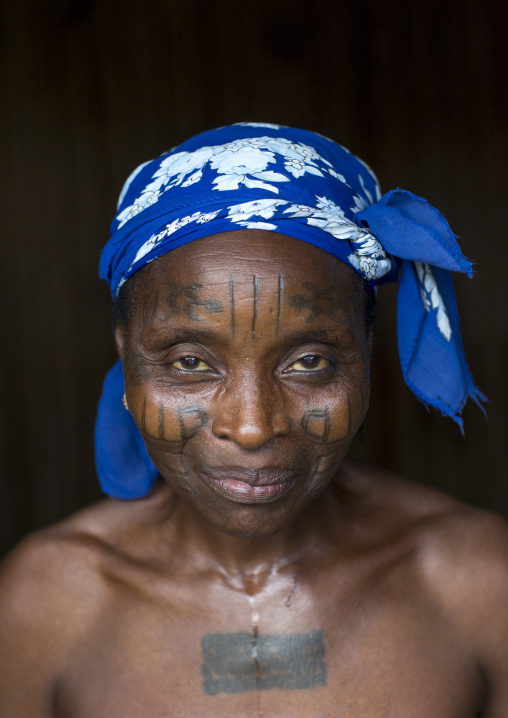 Benin, West Africa, Onigbolo Isaba, holi tribe woman covered with traditional facial tattoos and scars