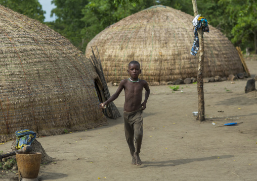 Benin, West Africa, Gossoue, a fulani peul tribe boy walking in his village