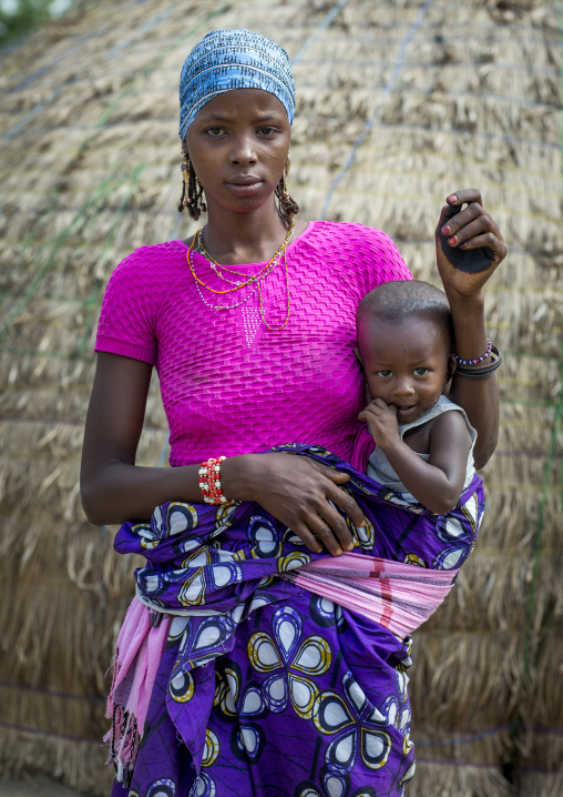 Benin, West Africa, Gossoue, a beautiful tattooed fulani peul woman with her baby