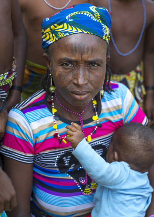 Benin, West Africa, Gossoue, a beautiful tattooed fulani peul tribe woman with her baby