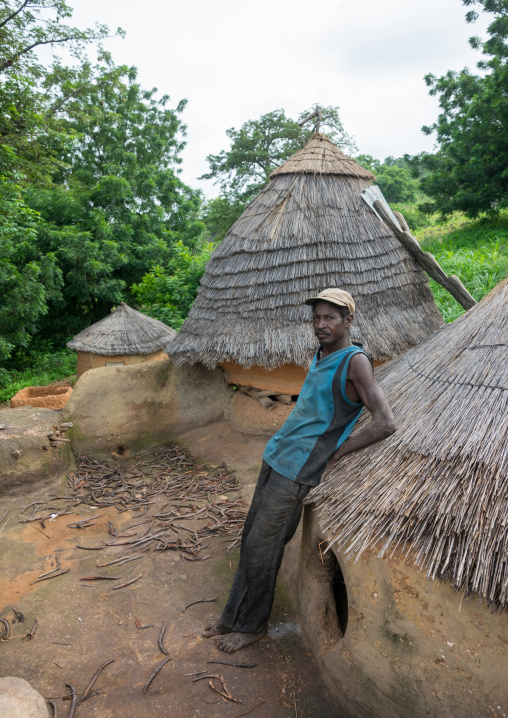 Togo, West Africa, Nadoba, man standing on the roof of a traditional tata somba house