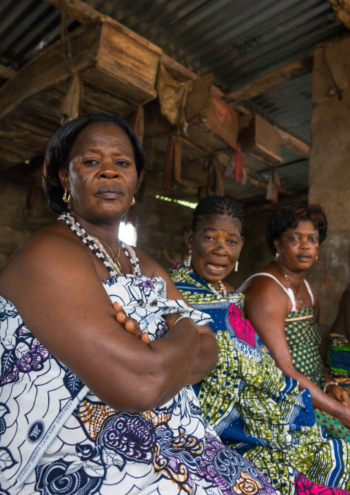 Benin, West Africa, Bopa, woman standing below coffins during a voodoo ceremony