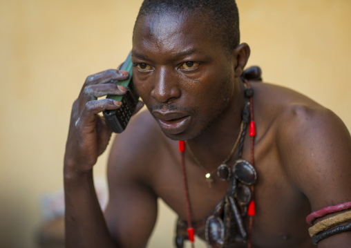 Benin, West Africa, Bonhicon, kagbanon bebe voodoo priest speaking on the phone