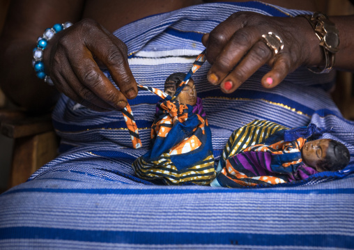 Benin, West Africa, Bopa, miss hounyoga dressing the carved wooden figures of her dead twins