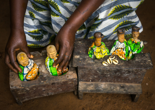 Benin, West Africa, Bopa, miss ablossi putting the carved wooden figures of her five dead twins in their box for daytime