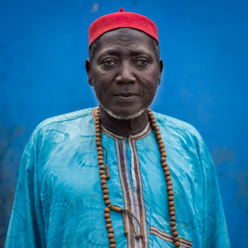 Benin, West Africa, Copargo, zachary muslim man standing in front of a blue wall