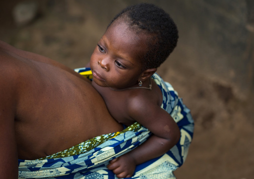 Benin, West Africa, Bopa, mother carrying baby on back