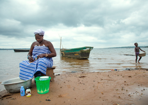 Benin, West Africa, Bopa, miss hounyoga washing the carved wooden figures made to house the soul of her dead twins