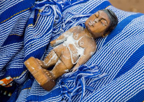 Benin, West Africa, Bopa, miss hounyoga washing the carved wooden figures made to house the soul of her dead twins