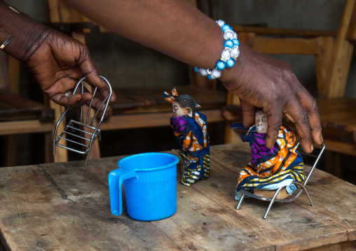 Benin, West Africa, Bopa, miss hounyoga giving food to the wooden figures made to house the soul of her dead twins