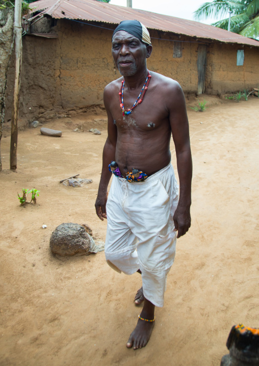 Benin, West Africa, Bopa, dah tofa carrying the carved wooden figures made to house the soul of his dead twins