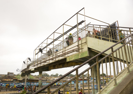 Benin, West Africa, Cotonou, people crossing the bridge over dantokpa market