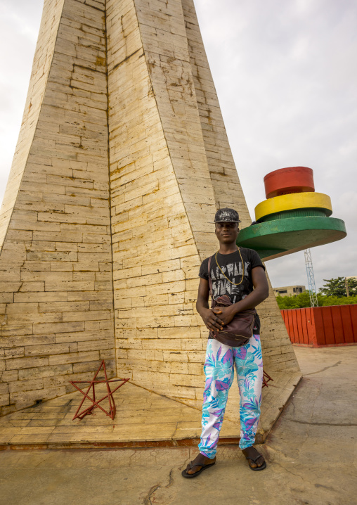 Benin, West Africa, Cotonou, man pausing in front of the red star square