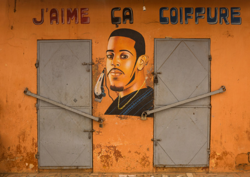 Benin, West Africa, Porto-Novo, a painted signboard in front of a hairdressing salon "i love this"