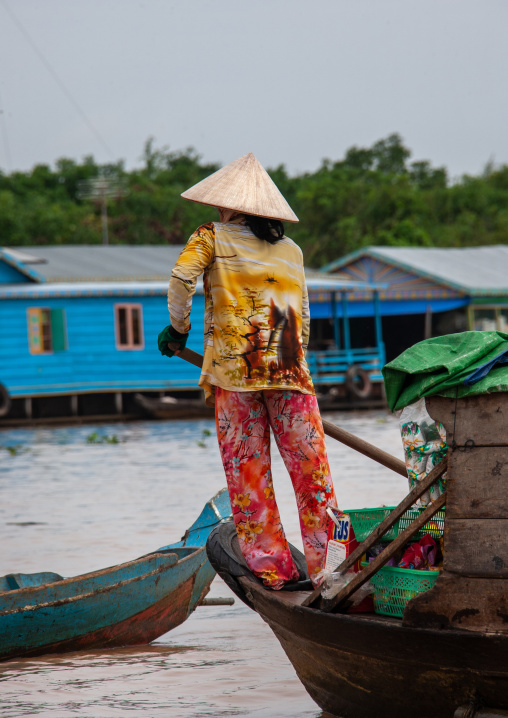 Cambodian woman rowing in the floating village on Tonle Sap lake, Siem Reap Province, Chong Kneas, Cambodia