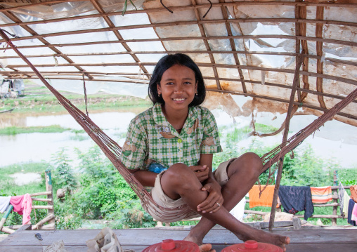 Cambodian girl on a hammock in the floating village on Tonle Sap lake, Siem Reap Province, Chong Kneas, Cambodia