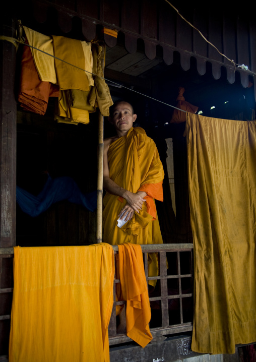 Cambodian monk in a monastery with robes drying, Battambang province, Battambang, Cambodia