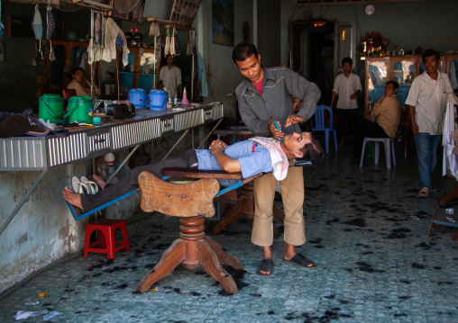 Men having their hair cut in a salon, Battambang province, Battambang, Cambodia