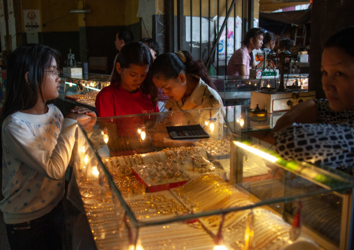 Cambodian women looking at gold jewelry in a market, Phnom Penh province, Phnom Penh, Cambodia