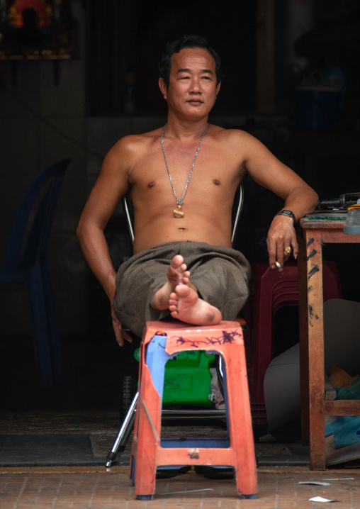 Portrait of a smiling cambodian relaxing in the street, Phnom Penh province, Phnom Penh, Cambodia