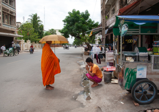Buddhist monk begging on a street, Phnom Penh province, Phnom Penh, Cambodia