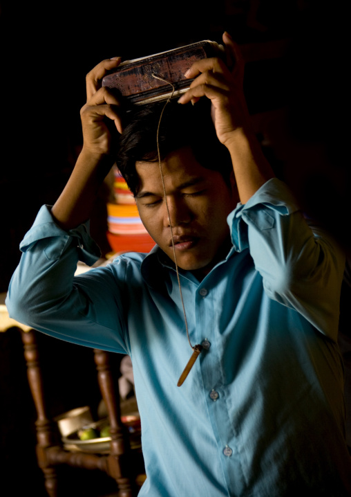 Cambodian man praying in a temple, Phnom Penh province, Phnom Penh, Cambodia