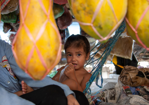 Cambodian girl on a hammock in a market, Phnom Penh province, Phnom Penh, Cambodia