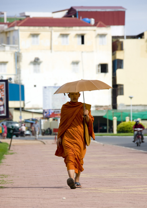 Cambodian monk walking in the street with umbrella, Phnom Penh province, Phnom Penh, Cambodia