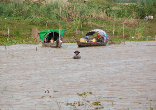 Cambodian woman putting fishing nets in a river, Phnom Penh province, Phnom Penh, Cambodia