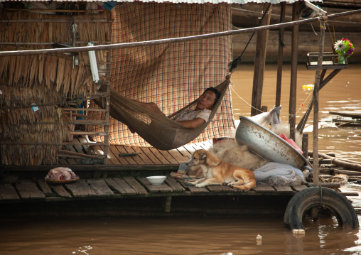 Cambodian man on a hammock in the floating village on Tonle Sap lake, Siem Reap Province, Chong Kneas, Cambodia