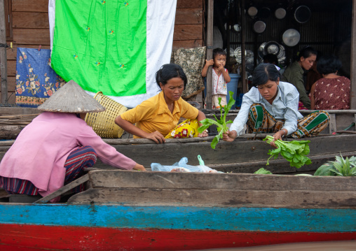 Women selling food on boats in the floating village on Tonle Sap lake, Siem Reap Province, Chong Kneas, Cambodia