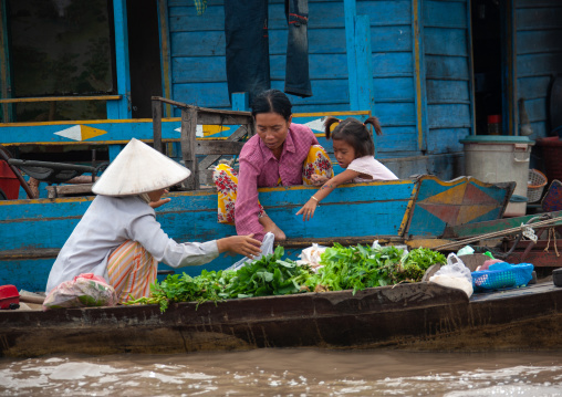 Cambodian women selling food on boats in the floating village on Tonle Sap lake, Siem Reap Province, Chong Kneas, Cambodia