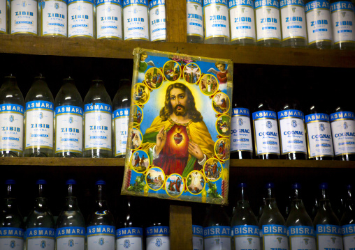 Jesus Poster In Front Of Zibib And Cognac Bottles, Central region, Asmara, Eritrea