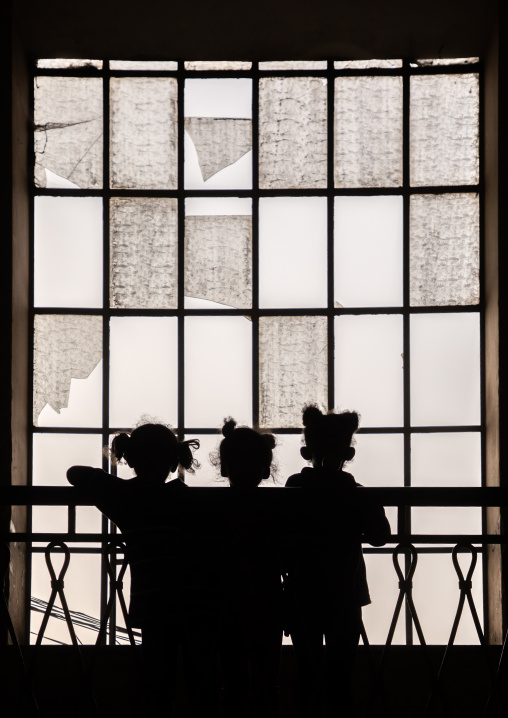 Silhouettes of children standing in front of a huge window, Central region, Asmara, Eritrea