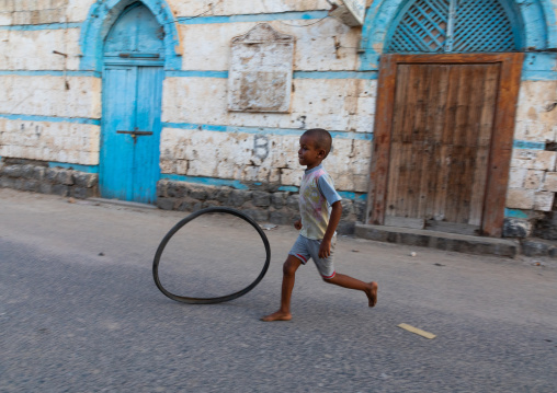 Boy playing in the street in front of an ottoman architecture house, Northern Red Sea, Massawa, Eritrea